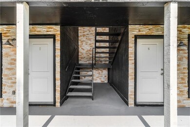 View of exterior entry featuring stone siding