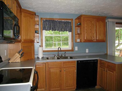 Kitchen. Features also include a tile floor and pl