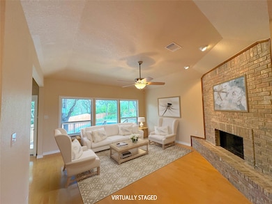 Living room featuring wood finished floors, a cei