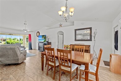 Dining area with arched walkways, light tile patte
