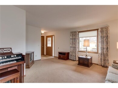 Spacious living room with large front window and t