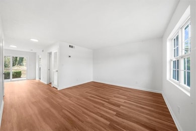 Spare room featuring wood finished floors and baseboards