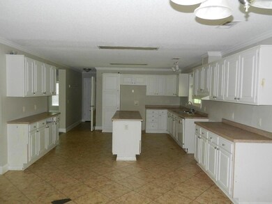 Kitchen with a center island, crown molding, white