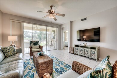 Tiled living area featuring a ceiling fan, visible