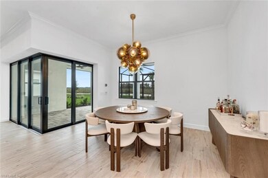 Dining space with crown molding, a notable chandel