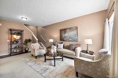 Carpeted living area featuring baseboards