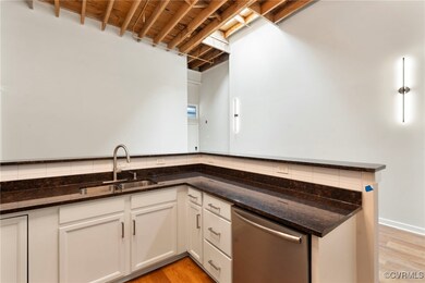 Kitchen featuring dishwasher, tasteful backsplash,