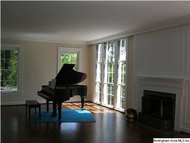 LIVING ROOM WITH FIREPLACE AND FLOOR-TO-CEILING WI