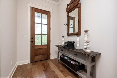 Lovely entryway is nice and wide, presenting tall ceilings & an impressive front door