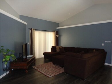 Living room with glass sliders to lanai and pool
