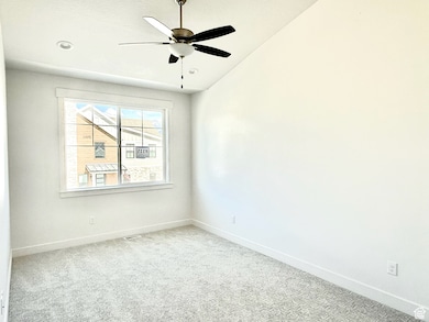 Spare room with carpet floors, a ceiling fan, vaulted ceiling, and recessed lighting