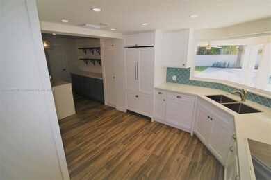 Custom wood cabinetry includes built-in refrigerator and dishwasher, as well as wine fridge in the island!