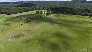 View of property location with a heavily wooded area and rural landscape