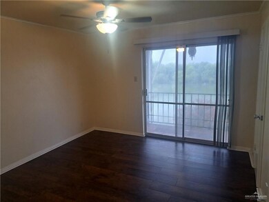 Unfurnished room with ceiling fan, dark wood finished floors, ornamental molding, and baseboards