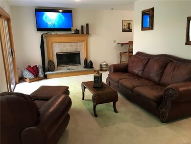 Another view of living room with the fireplace to 