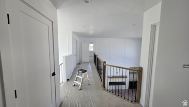 Hall featuring an upstairs landing and carpet floors