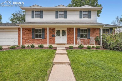 Front facade featuring a front lawn, a garage, and