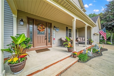View of exterior entry featuring covered porch