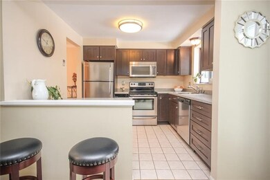 Newer kitchen with stainless appliances overlooks 