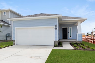 View of front facade with driveway, an attached g