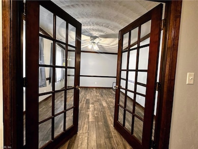 French doors open up to the left across from the stairs.  This could be a formal Livingroom/dining area or a private office.