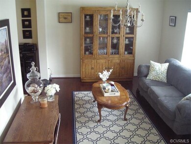Living room is spacious with pretty wood floors