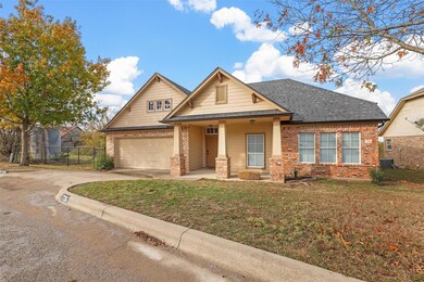 View of front facade with a garage, a front lawn, 