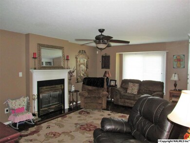 Family room with beautiful parquet wood flooring and gas fireplace.
