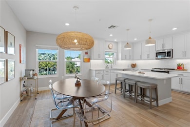 Dining area off spacious kitchen. White quartz with hints of veining. 46 X 72 in Island with loads of storage.
