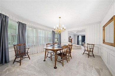 Dining room featuring a chandelier, crown molding,