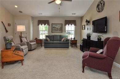 Large living room with ceiling fan and lots of nat