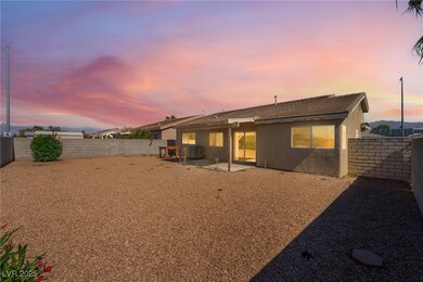 Back of house at dusk featuring stucco siding, a f