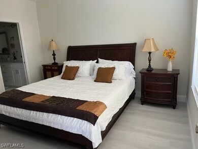 Bedroom with ensuite bathroom and light hardwood / wood-style flooring
