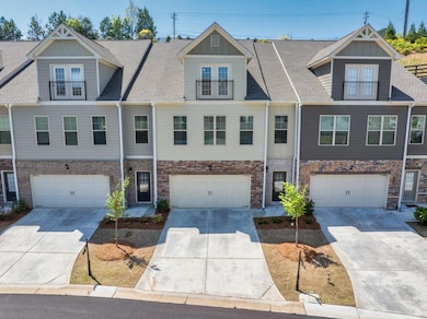 Townhome / multi-family property featuring an atta