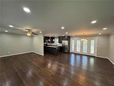 Unfurnished living room with recessed lighting, ba