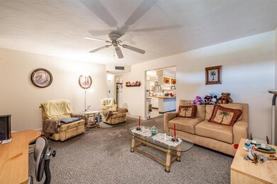 The floor plan flows through the spacious living room into the dining which is open to the kitchen and also offers access to the ENCLOSED LANAI via SLIDING GLASS DOORS!