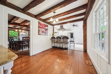Updated kitchen with vaulted ceilings, bay window, wood beams and kitchen island
