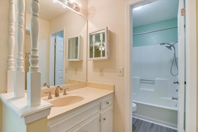 Bathroom featuring vanity, a textured ceiling, sh