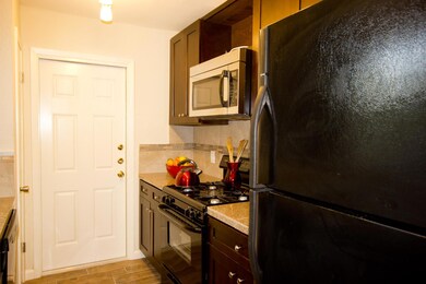 Kitchen featuring backsplash, light wood-style fl