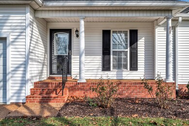Farmhouse front porch with mature trees and friendly neighbors