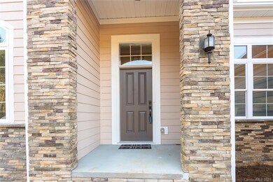 Covered entry with stone accents.