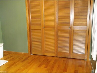 Bedroom has hardwood flooring and double closets