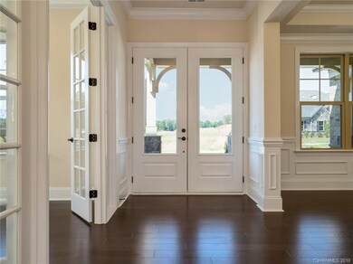 Breathtaking double front door entry, with 10' cei