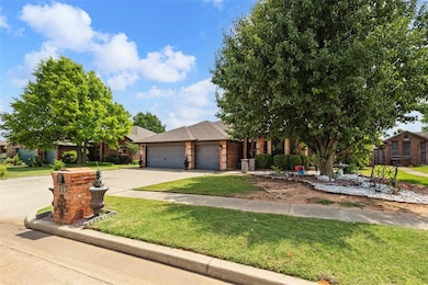 View of front facade featuring brick siding, a garage, a front yard, driveway, and a shingled roof