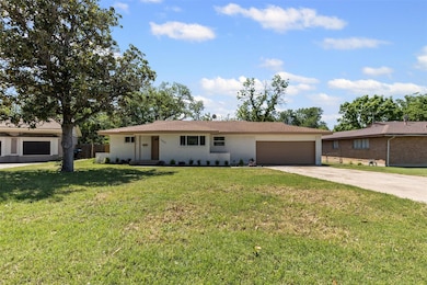 Single story home featuring an attached garage, a 