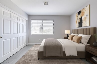 Bedroom with wood finished floors, baseboards, and