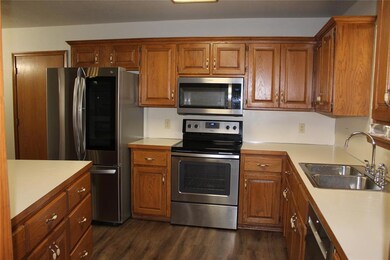 Kitchen with sink, dark wood-type flooring, and st