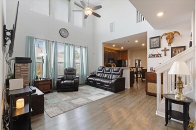 This open and airy living space features tall ceil