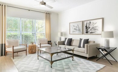 Living area featuring ceiling fan and light wood f