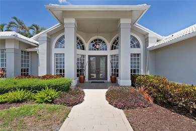 Doorway to property featuring french doors and stucco siding